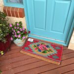a doormat on a porch with roses
